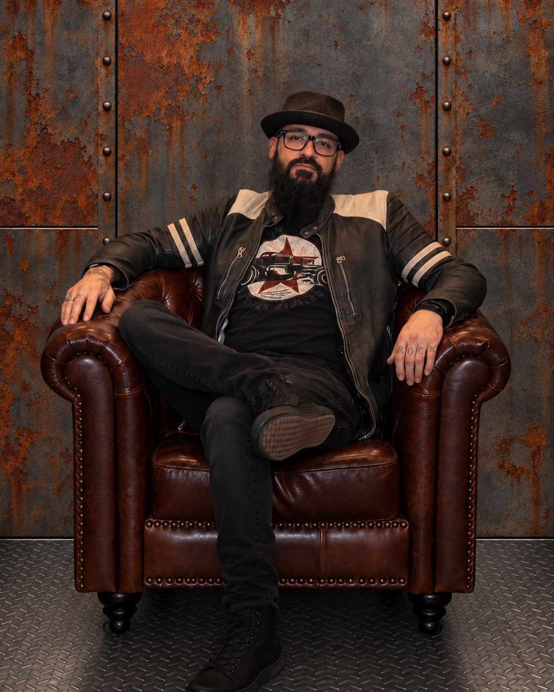 Raff Mc Duff, bass, seated in a leather armchair